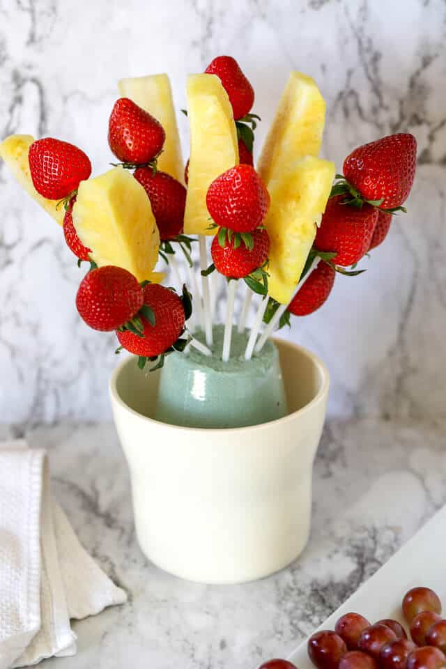 Pineapple and strawberries on plastic sticks in a fruit bouquet