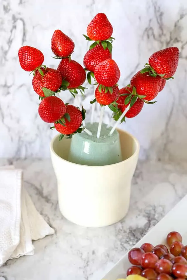 strawberries in a fruit arrangement on plastic skewers