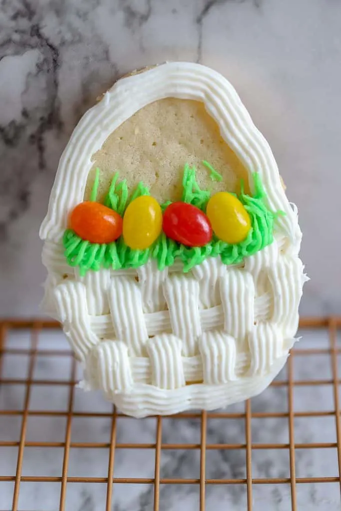 Easter Basket decorated cookie with white woven icing effect and jelly beans