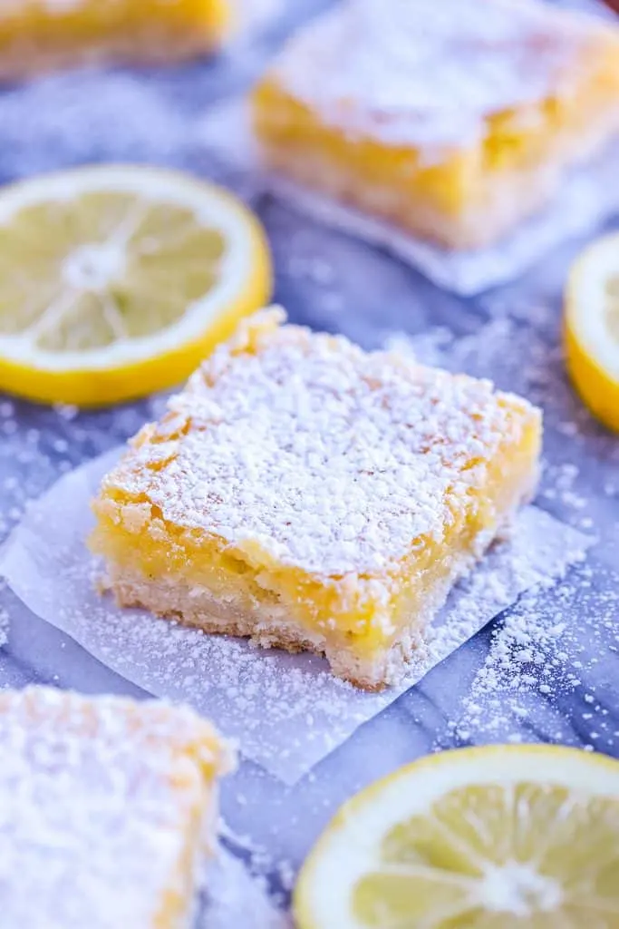 Lemon Square with lemon slices on parchment paper