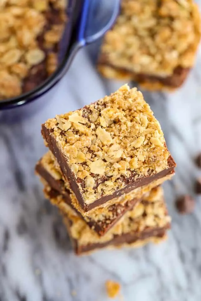 Stack of three Oatmeal Fudge Bars with the tray of bars in the background