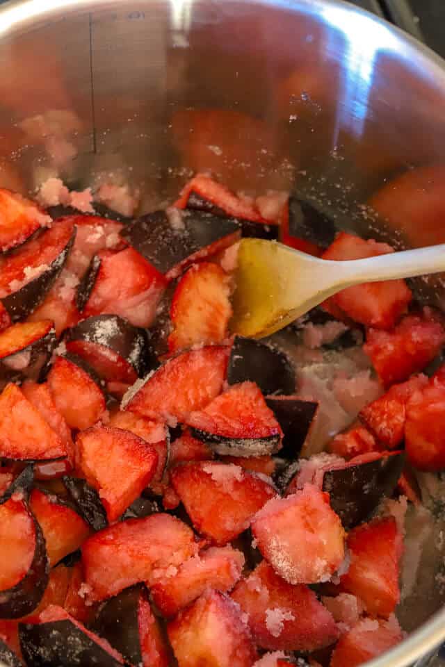 Plums boiling in sauce pan making plum jam recipe