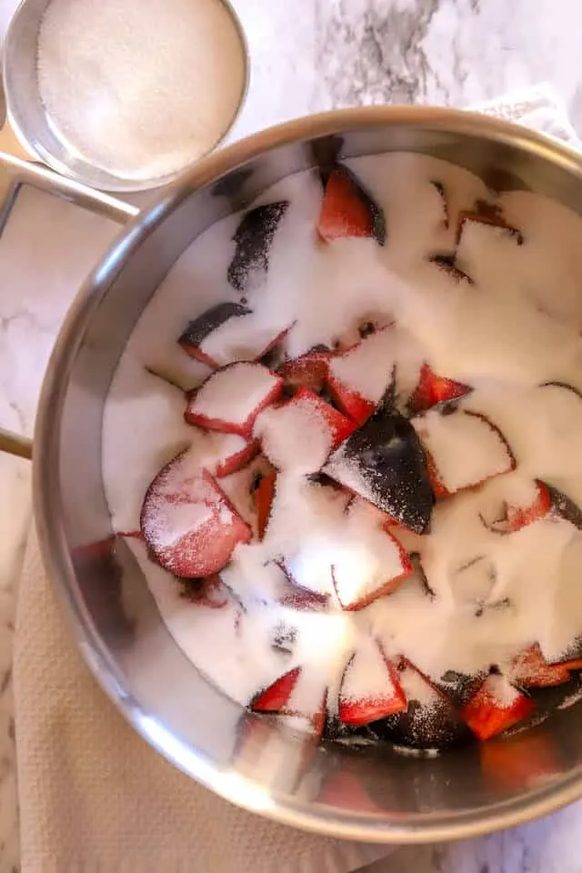 Sugar added to plums while making plum jam recipe