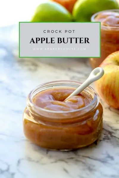 Crock pot apple butter in a glass jar with a white small spoon Pin photo