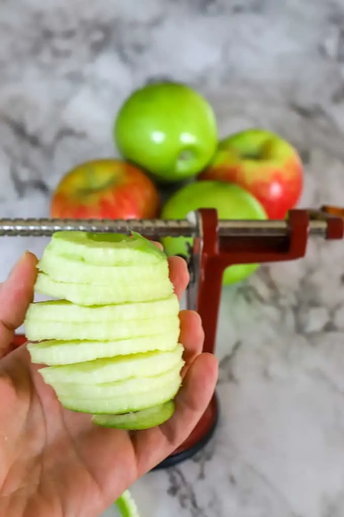 Peeled and cored apple using the apple peeler creates rings of apple slices all connected