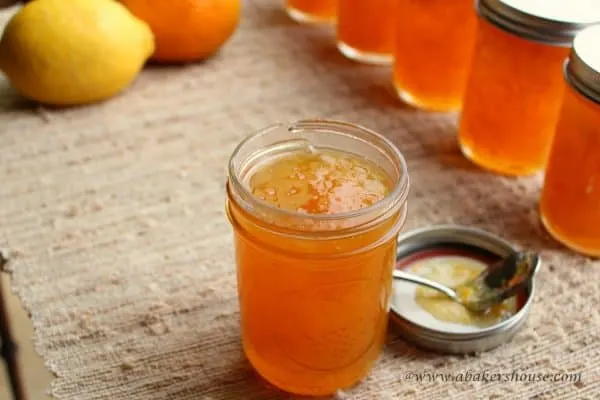 Orange lemon marmalade in a mason jar on burlap cloth