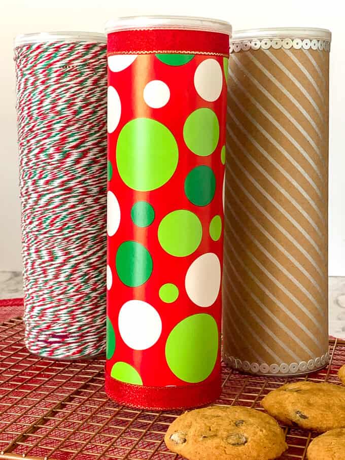 Three decorated Pringles cans that hold cookies
