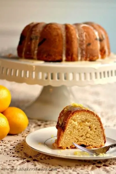 Lemon Bundt cake with a slice of cake on a white plate