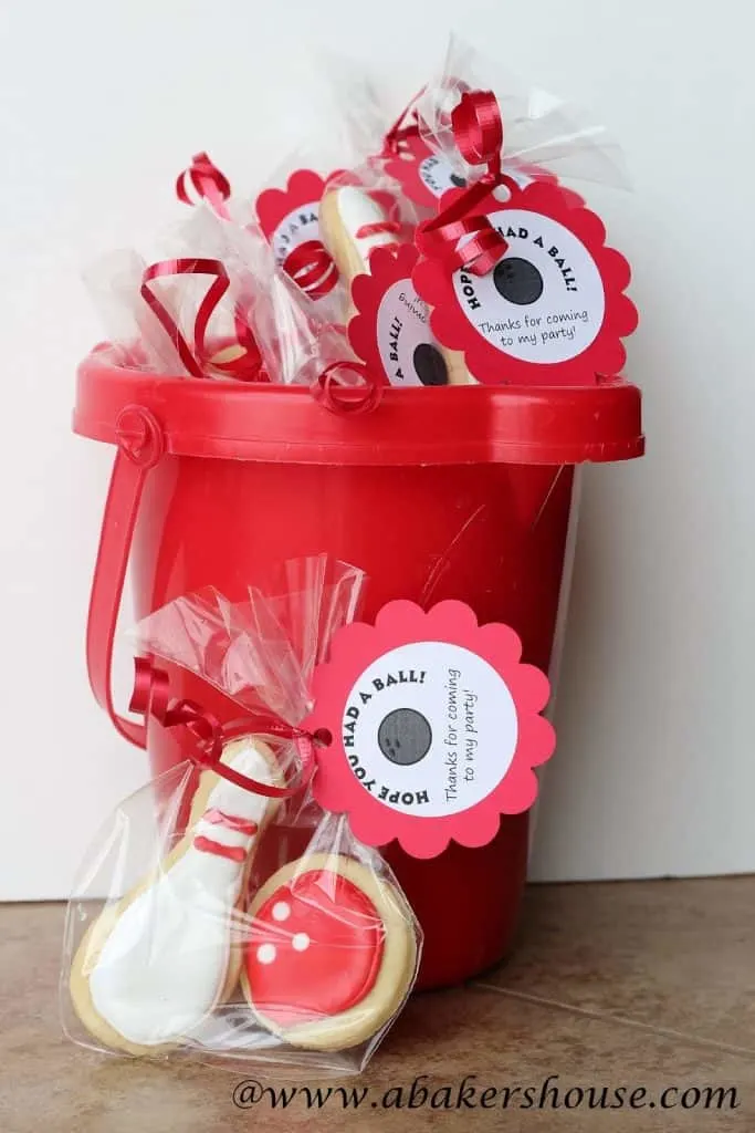 Bowling party favors in a red bucket ready for bowling themed party