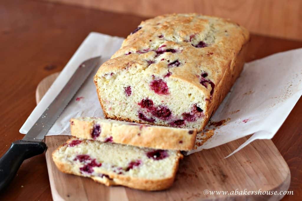 freshly baked raspberry quick bread with frozen raspberries baked in