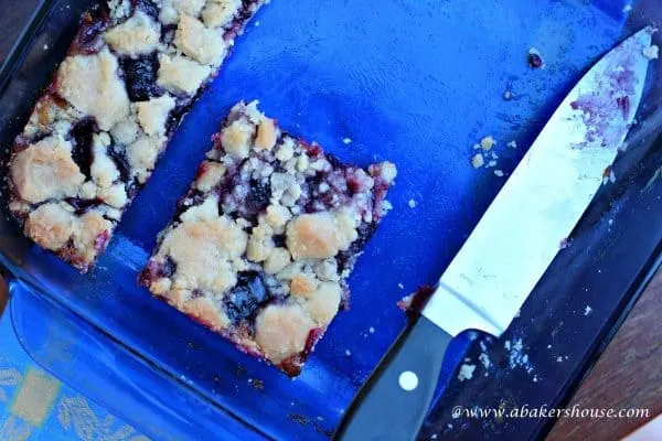 cut blueberry lemon squares in a blue pan