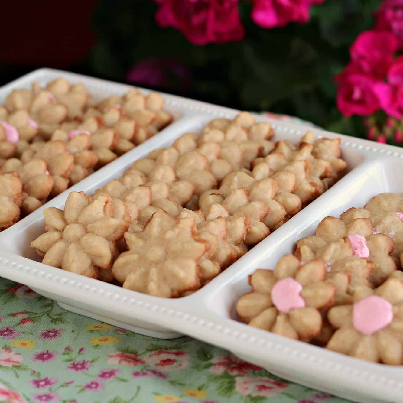 Spritz flower cookies on a white tray