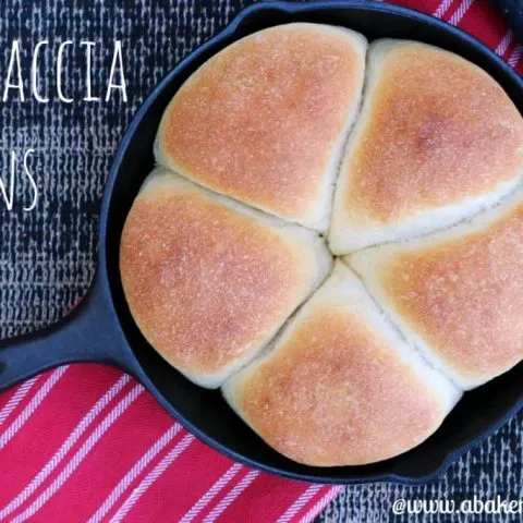 overhead photo of focaccia buns in cast iron pan