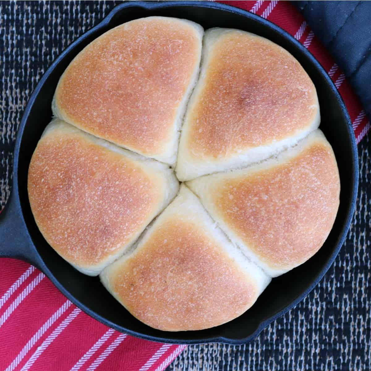Overhead photo of focaccia buns in cast iron pan