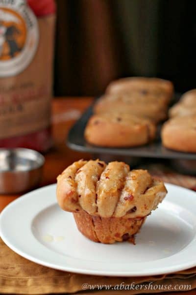 Onion bacon fantan on white plate with muffin tin in background