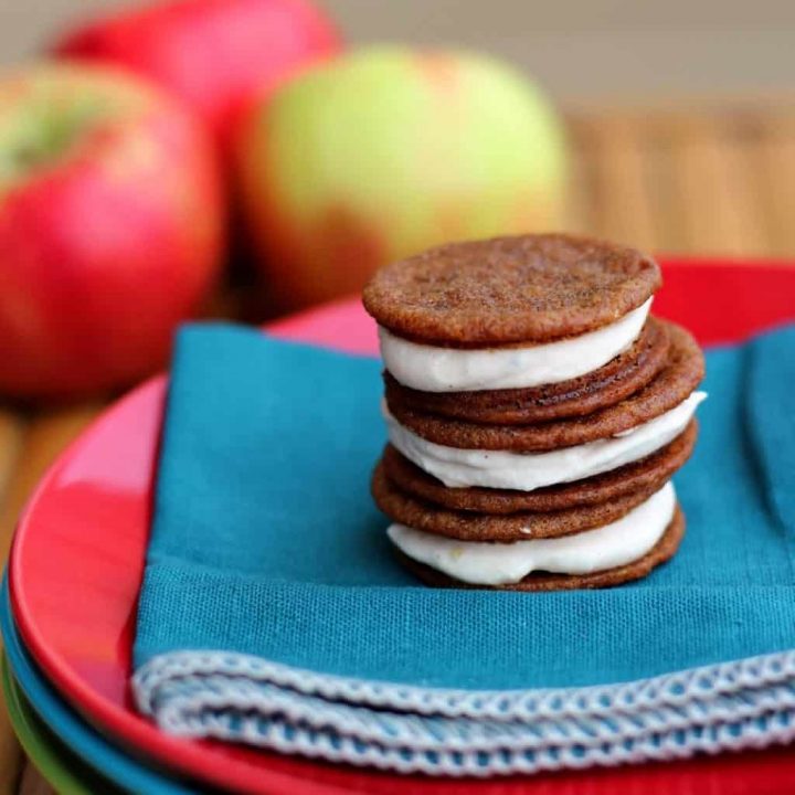 Stack of three ginger sandwich cookies with apple buttercream filling