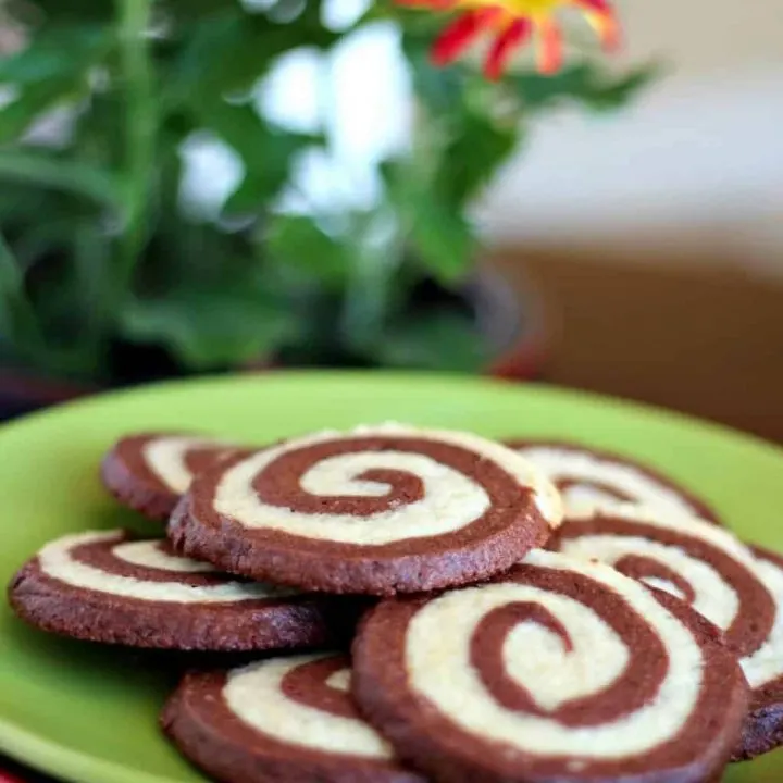 espresso pinwheel cookies on a green plate