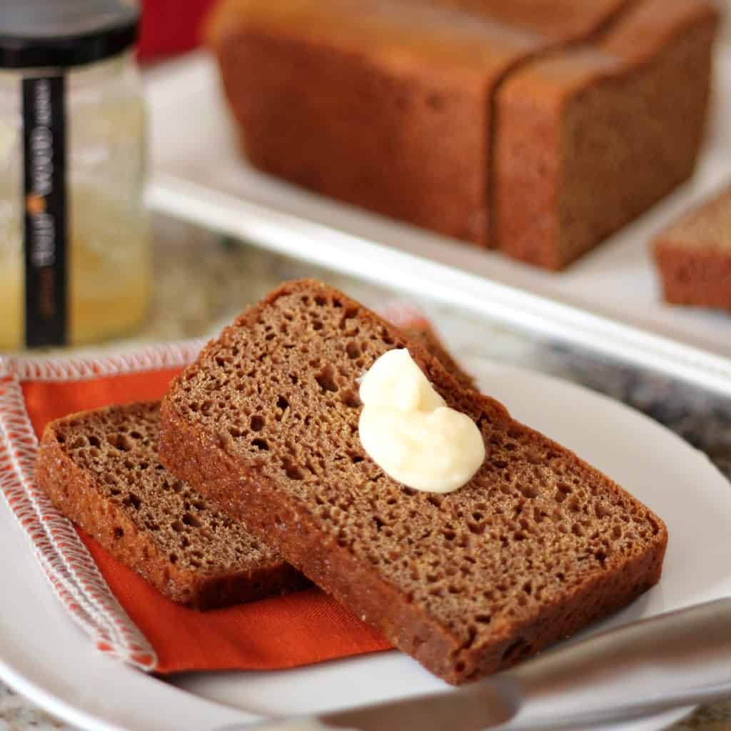 honey spice bread sliced on white plate with orange napkin