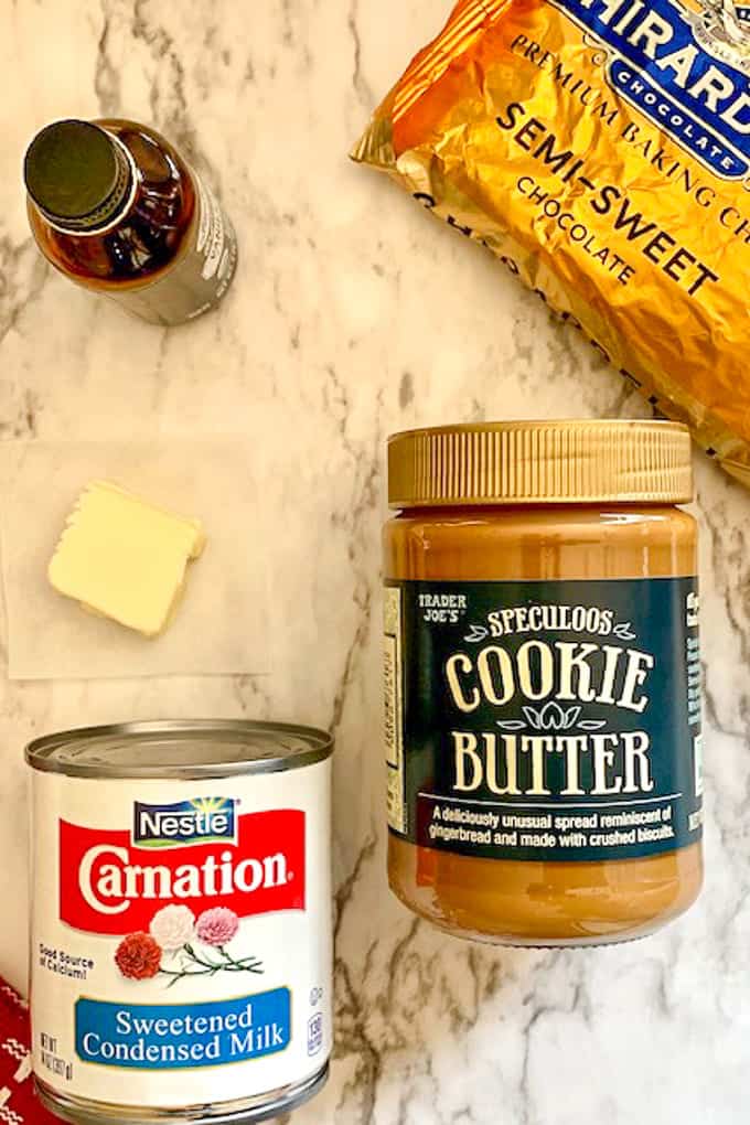 Ingredients for cookie butter fudge on a marble countertop