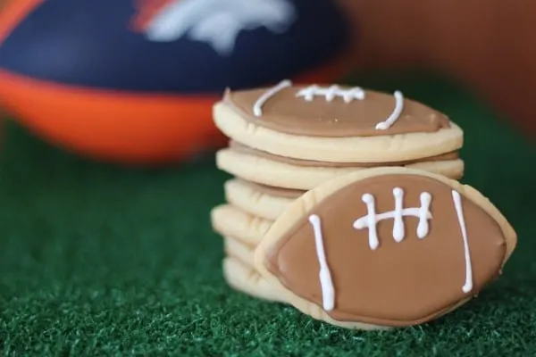 football cookies sugar cookies decorated with brown and white royal icing
