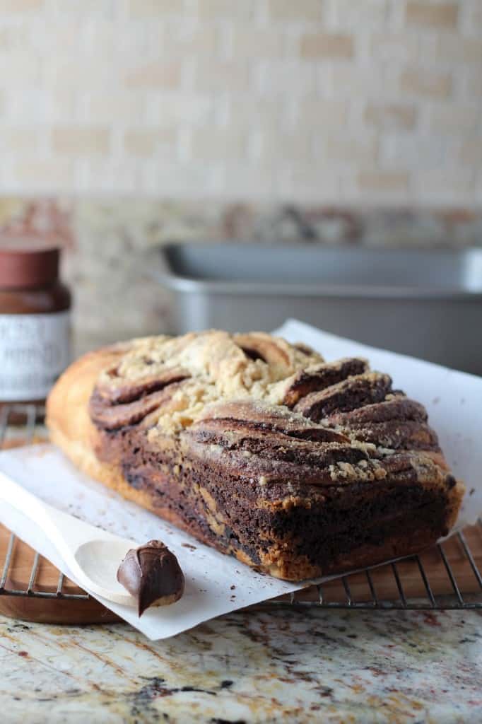 chocolate swirl bread baked loaf on kitchen counter with spoonful of nutella