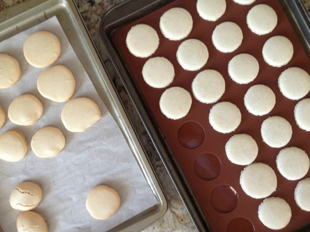 macaron baking sheet on right side with good macarons and baking tray on left with misformed macaron shells