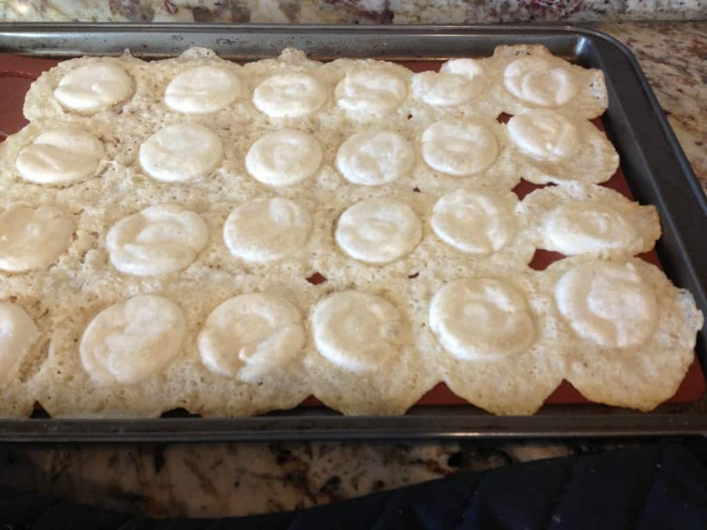 failed baked macarons that spread into a large blob on a baking sheet