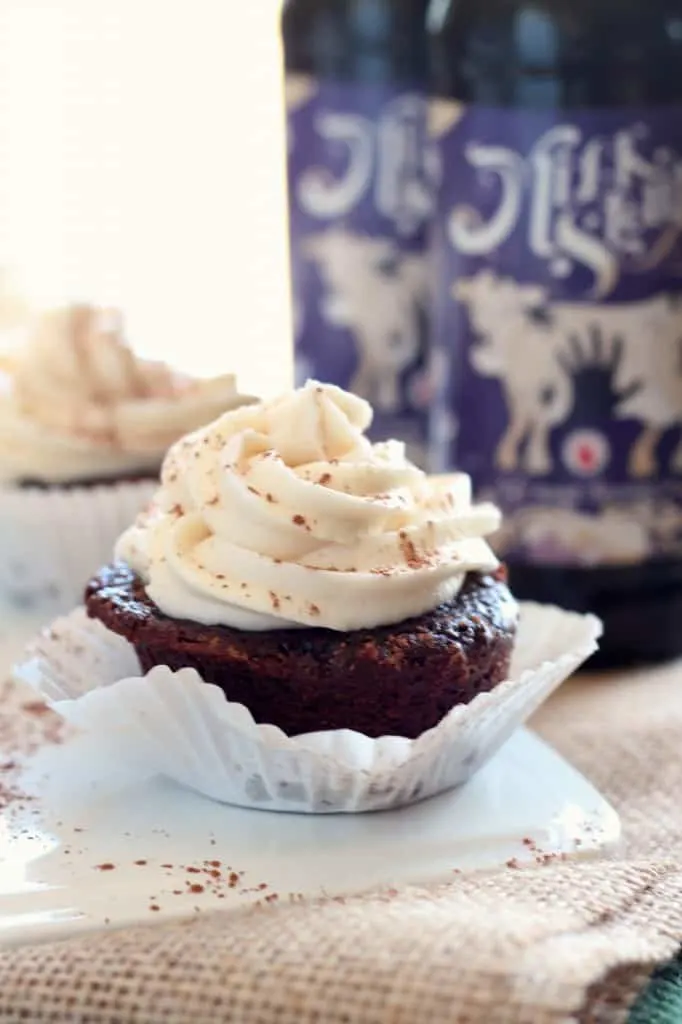 cocoa stout cupcake with white cupcake liner on white plate