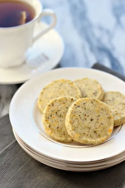 Five cookies on stack of white plates