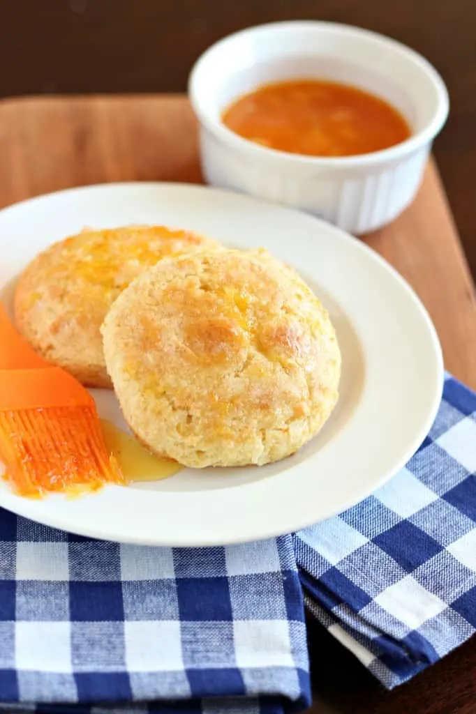 orange marmalade scones on white plate with blue checkered napkin