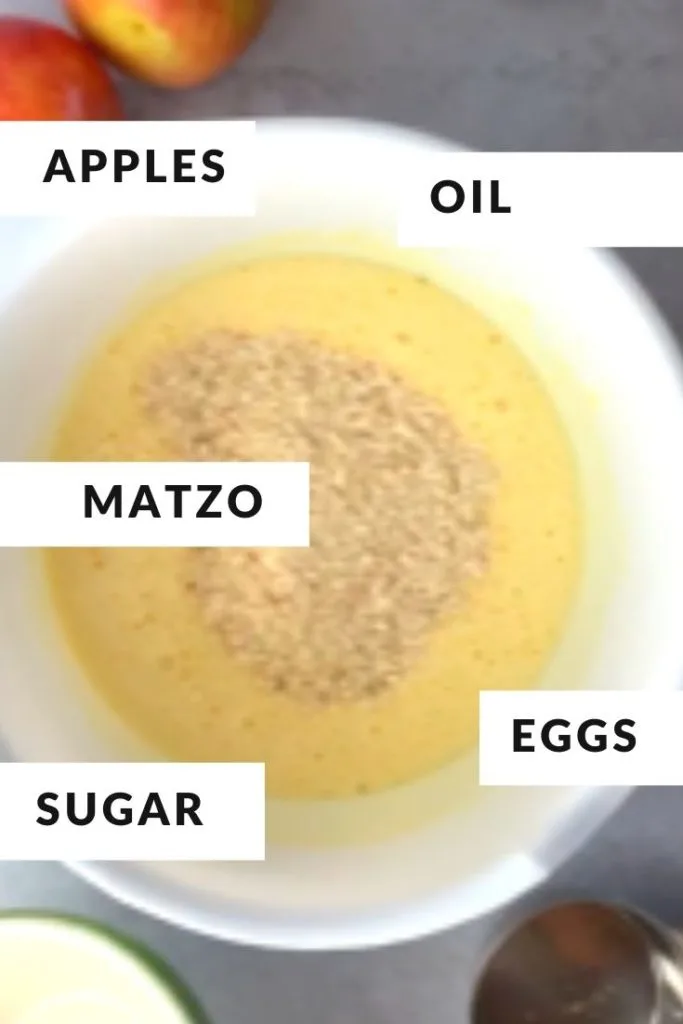 cake batter ingredients in a white bowl labeled as matzo, oil, eggs and sugar