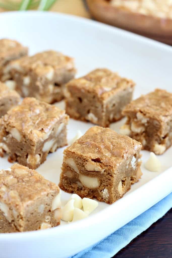 macadamia nut squares cut into pieces on a white serving tray