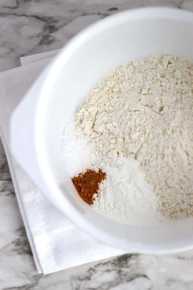 Dry ingredients of flour, baking powder and salt and nutmeg for cherry quick bread.