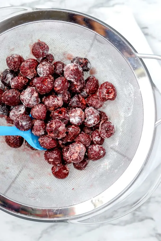 Toss frozen cherries in flour before adding to the bread