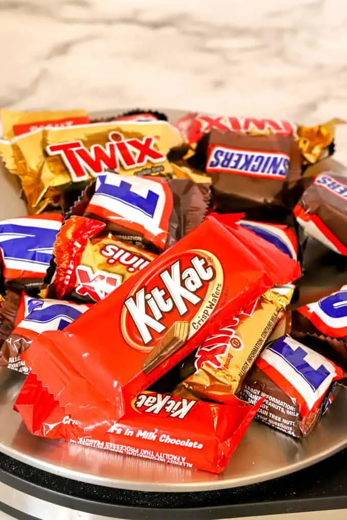 A pile of Halloween candy on a kitchen scale