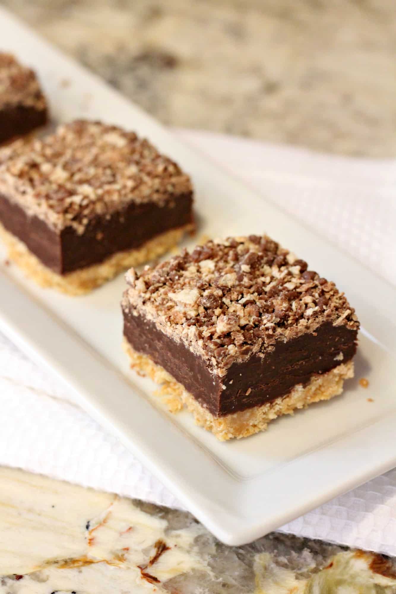 three kit kat bars on a white plate