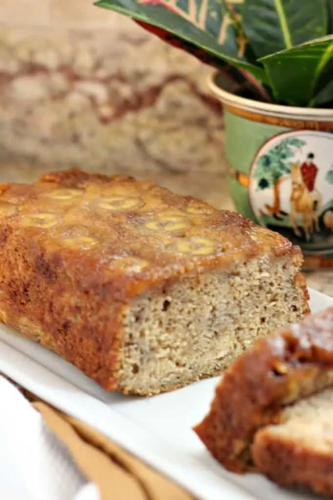 upsidedown banana bread sliced on a white platter