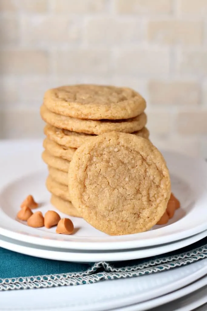 eight butterscotch cookies in a stack with one leaning in front