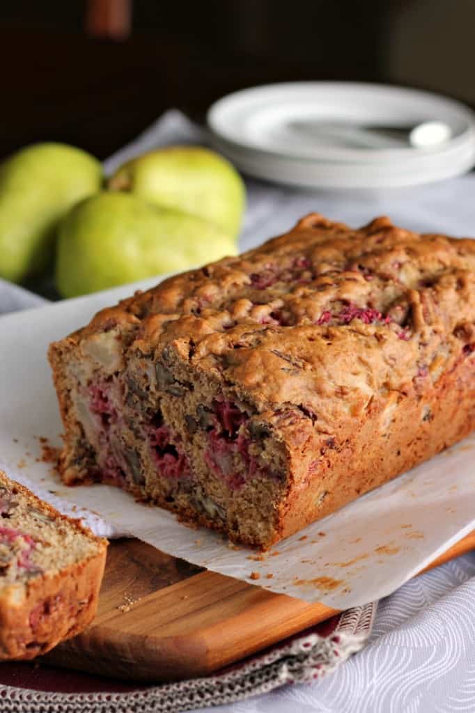 pear bread baked loaf on white serving platter with pears in background