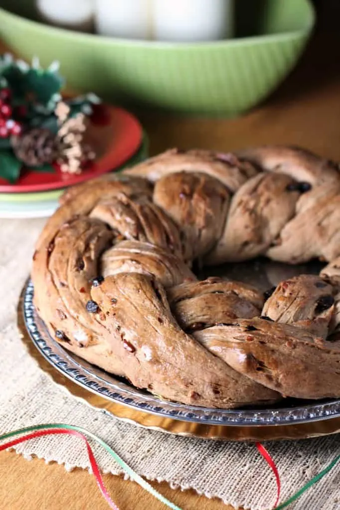 Raisin and Nut Wreath Bread on a silver and gold plate with festive touches in background