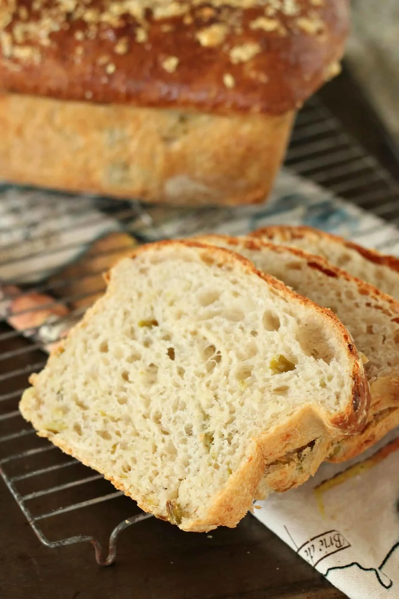 sliced hatch chile bread with loaf in background
