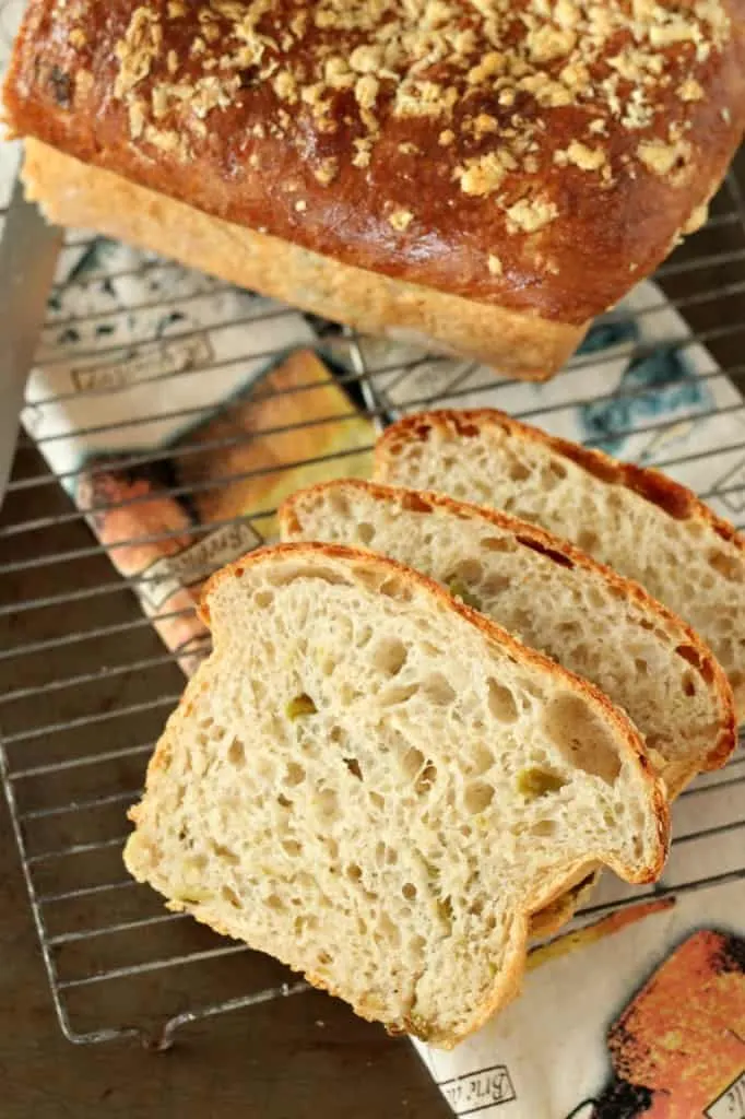hatch chile bread sliced on baking rack with loaf in background