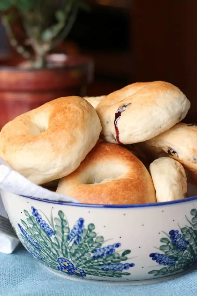 Homemade blueberry bagels in a pottery bowl