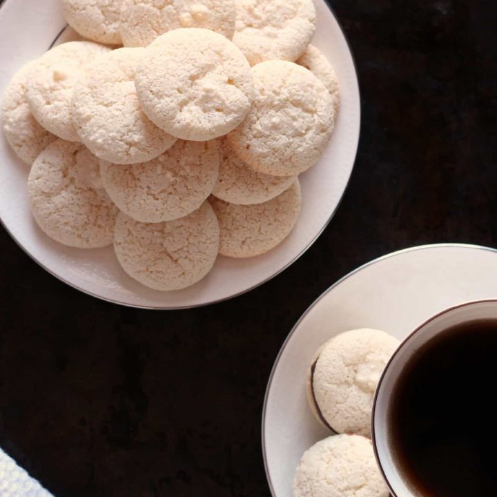 Ameretti biscuits piled on a white plate
