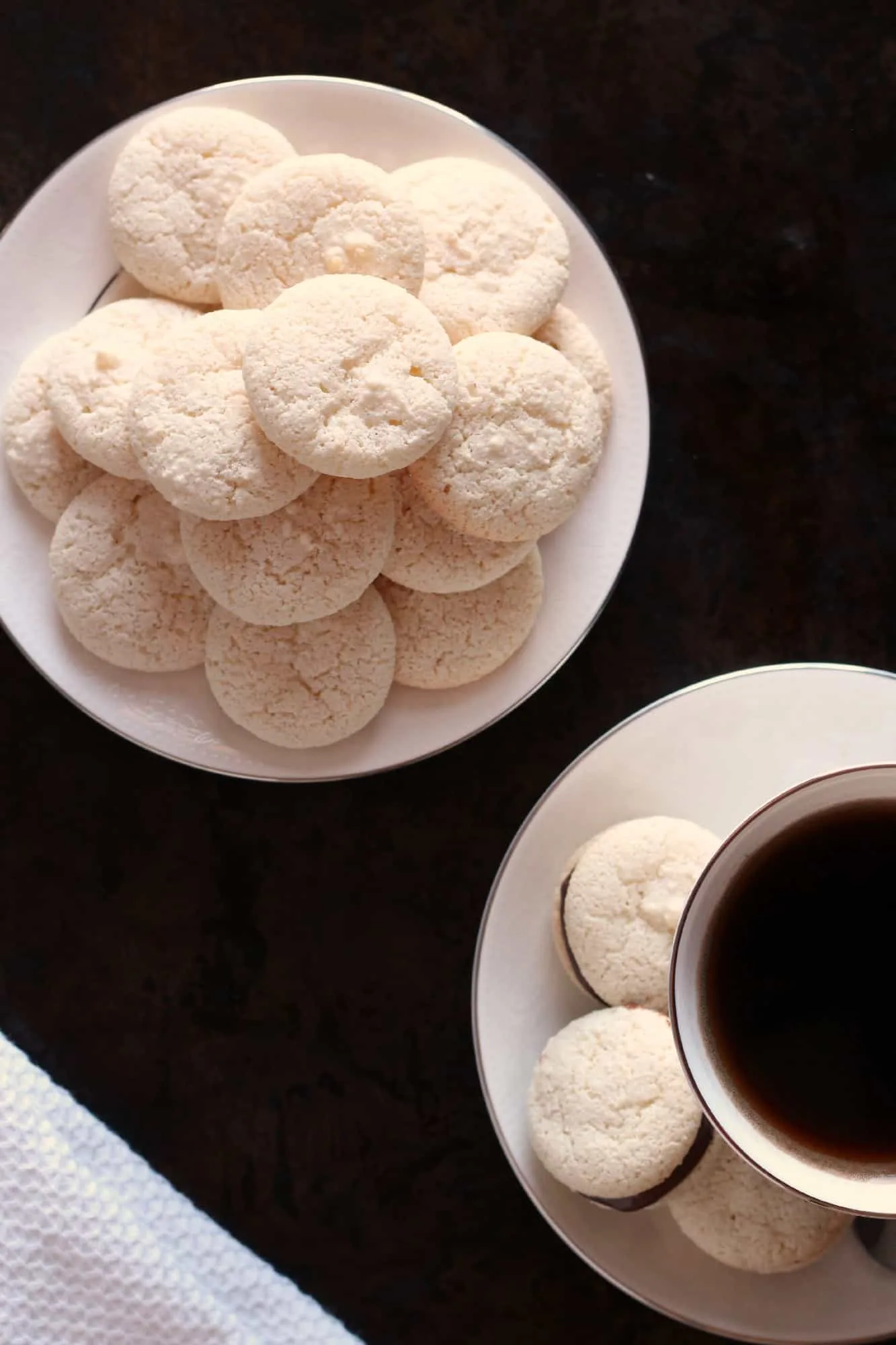 Ameretti biscuits piled on a white plate