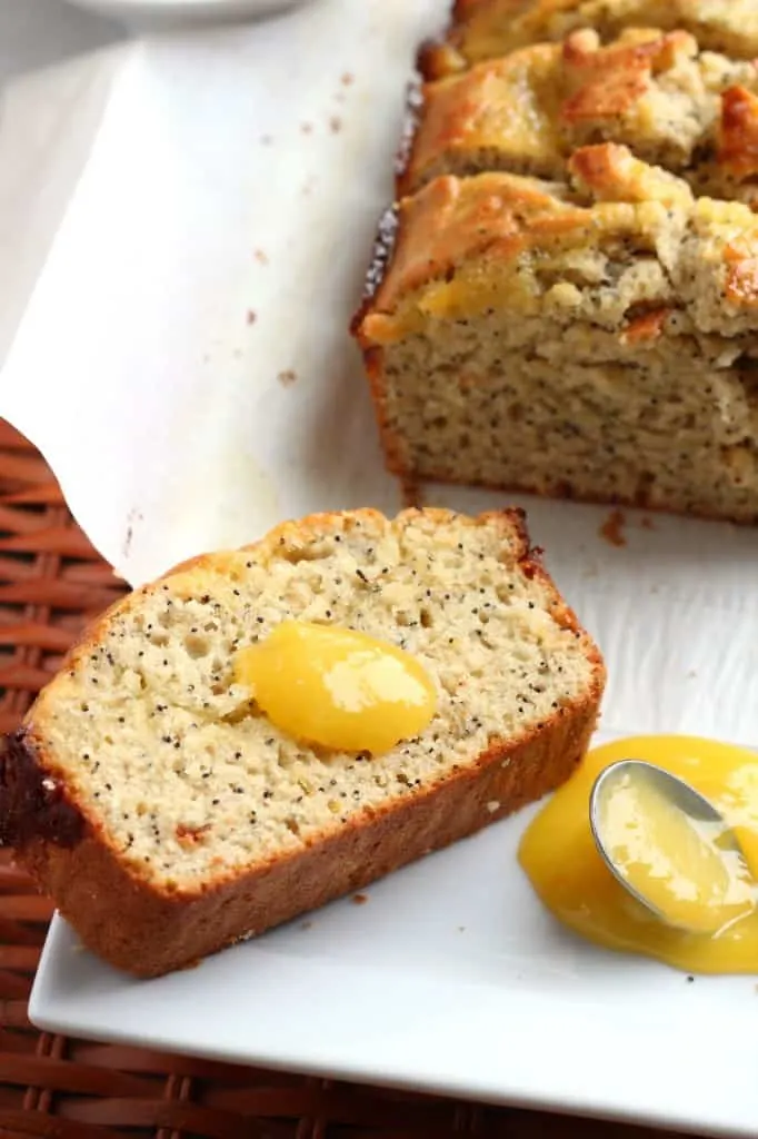 lemon poppy seed bread with spoon of lemon curd