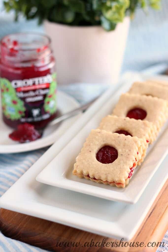 stack of linzer cookies on a white tray