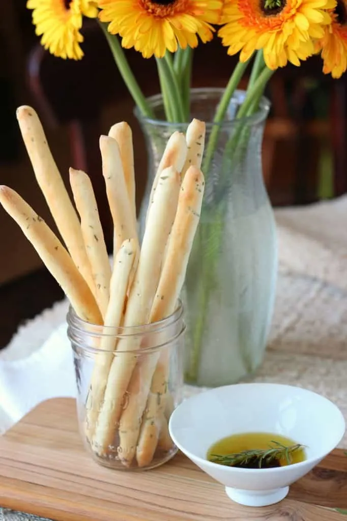 rosemary breadsticks served in a bunch inside a mason jar
