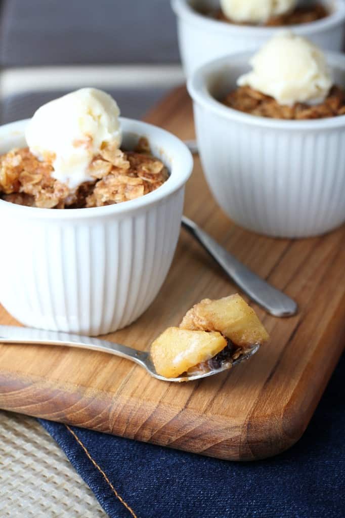 Two individual Apple Crisps with spoonful of apples