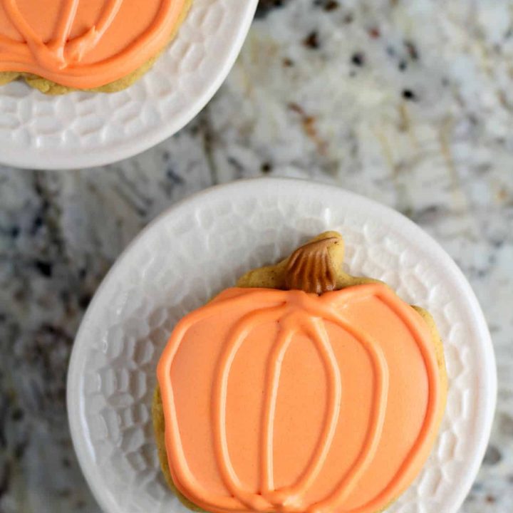 Pumpkin spice cut out cookies on a granite countertop